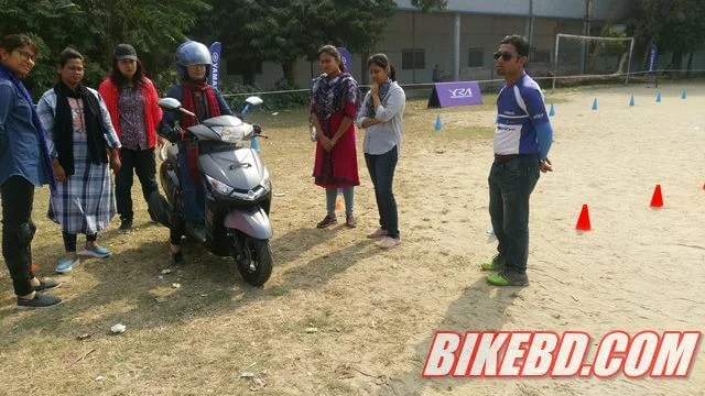 women riding raining in bangladesh